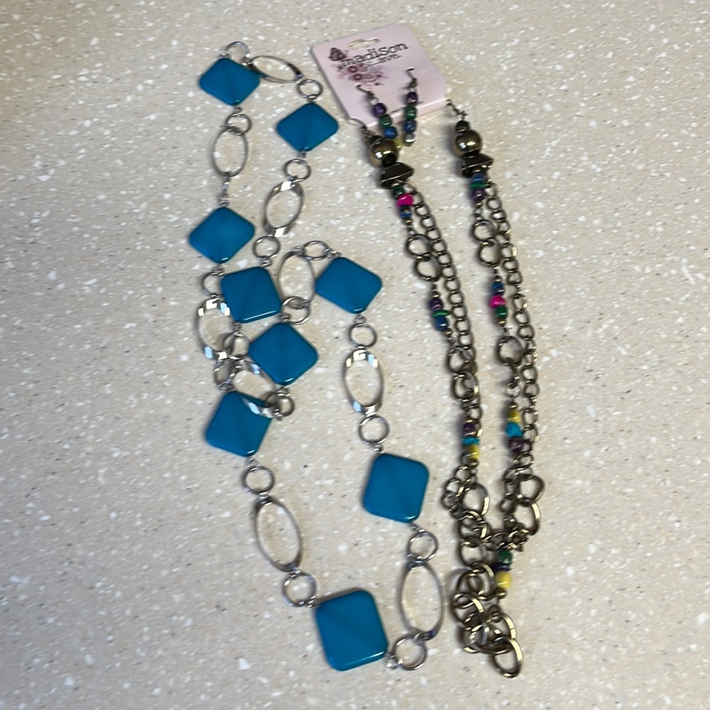 Two necklaces and one has earrings